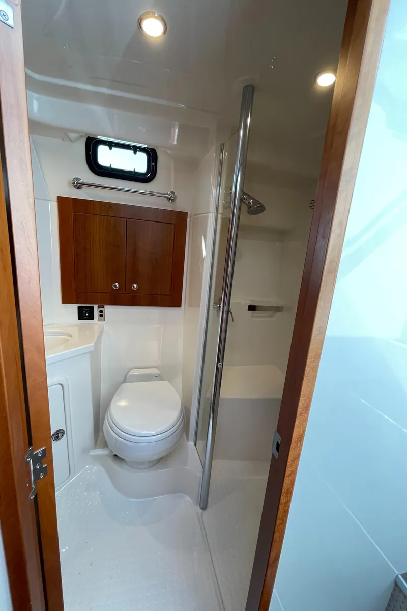 Slide: The Image of Bathroom interior of 2017 Riviera 3600 Sport Yacht with shower and wooden cabinet. - 43
