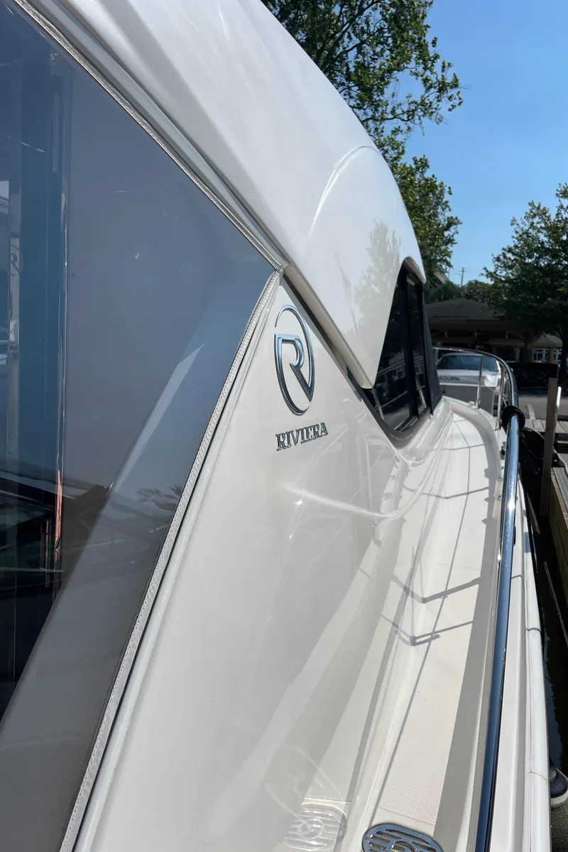 Slide: The Image of 2017 Riviera 3600 Sport Yacht, sleek design, docked under clear blue sky. - 45