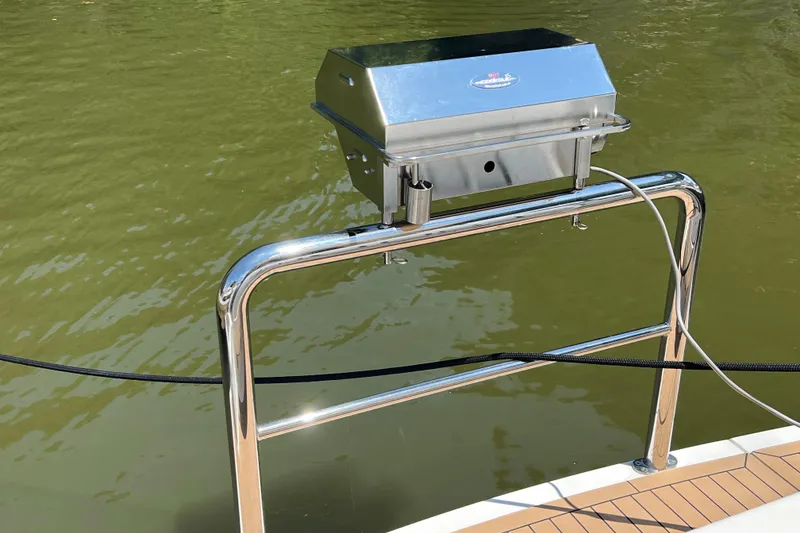 Slide: The Image of Stainless steel grill on 2017 Riviera 3600 Sport Yacht, overlooking calm green water. - 56