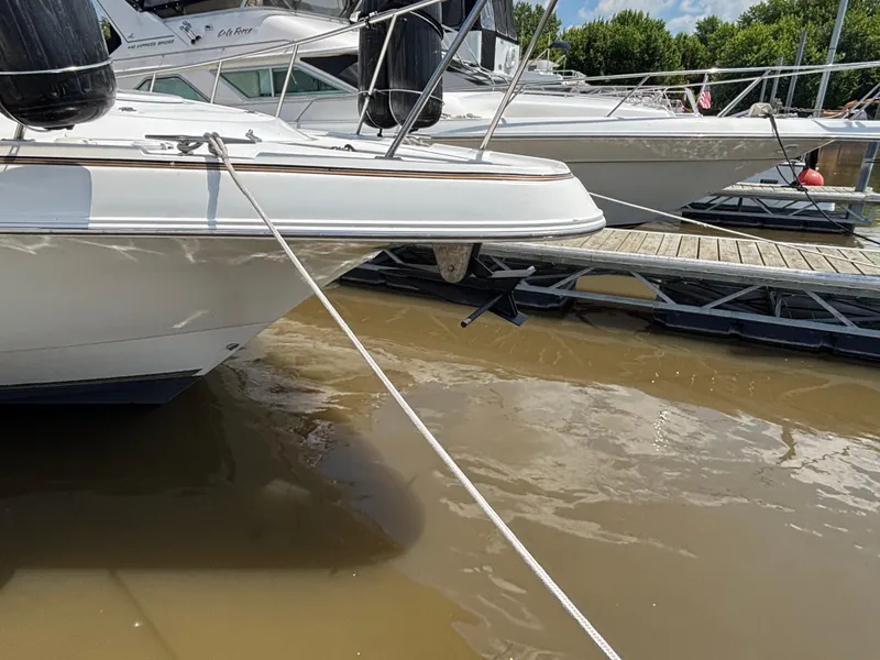 Slide: The Image of 1998 Cruisers Yachts 3575 Express docked at marina, calm water, sunny day. - 1