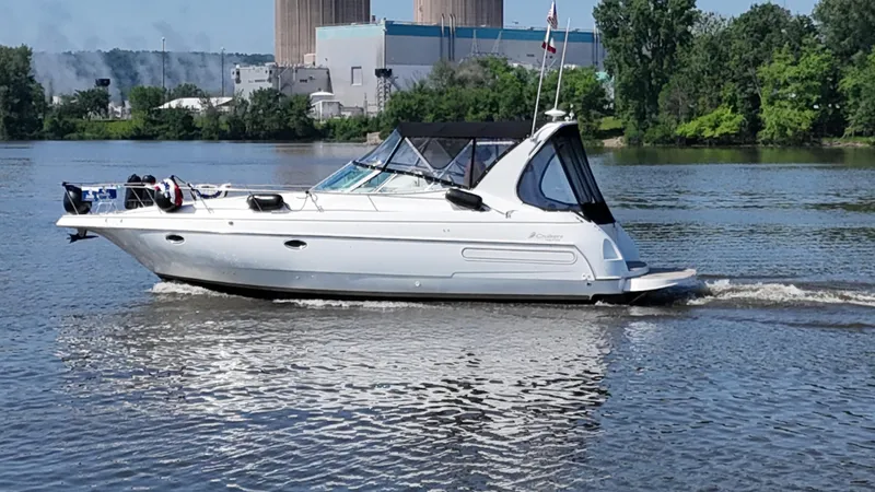 Slide: The Image of 1998 Cruisers Yachts 3575 Esprit on a calm river with industrial backdrop. - 14