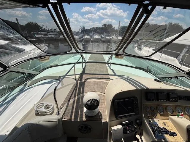 Slide: The Image of 1998 Cruisers Yachts 3575 Express cockpit view with marina in background. - 4