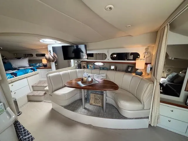Slide: The Image of 1998 Cruisers Yachts 3575 Express interior with cozy seating and modern amenities. - 7