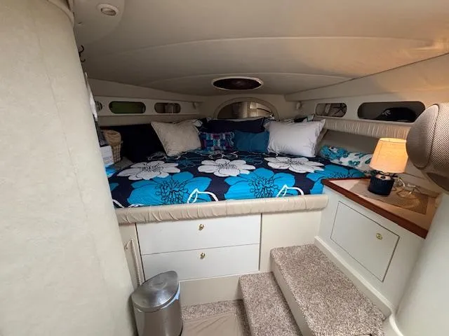 Slide: The Image of 1998 Cruisers Yachts 3575 Express cabin with floral bedding and cozy interior. - 9