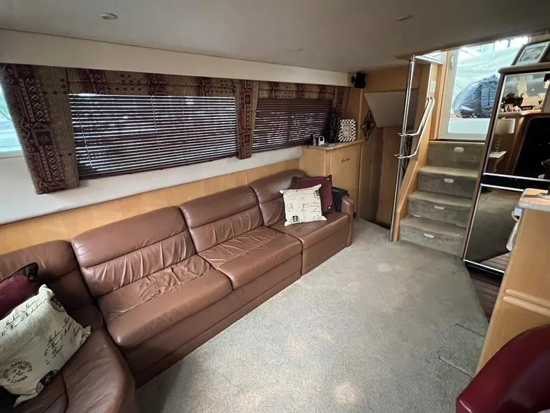 Slide: The Image of Interior of 1998 Carver 455 Aft Cabin Motoryacht with leather sofa and carpeted floor. - 11