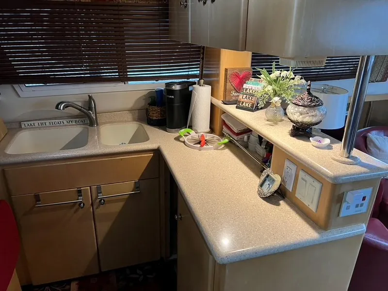 Slide: The Image of 1998 Carver 455 Aft Cabin Motoryacht kitchen with sink, decor, and countertop appliances. - 14