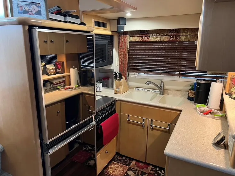 Slide: The Image of 1998 Carver 455 Aft Cabin Motoryacht kitchen with modern appliances and cozy decor. - 15