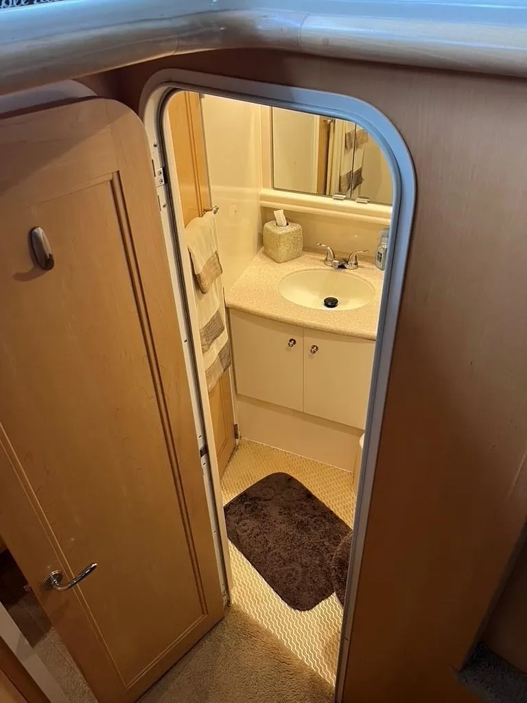 Slide: The Image of 1998 Carver 455 Aft Cabin Motoryacht bathroom with sink, mirror, and towel. - 16