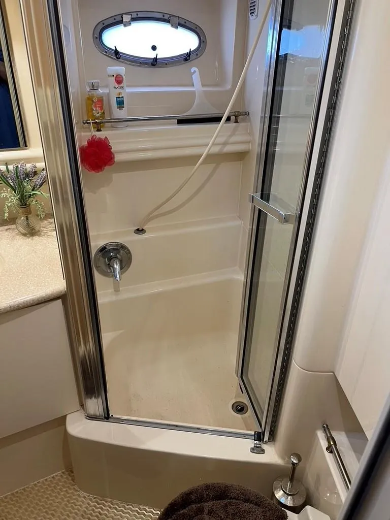 Slide: The Image of Shower area in 1998 Carver 455 Aft Cabin Motoryacht with glass door and porthole window. - 17