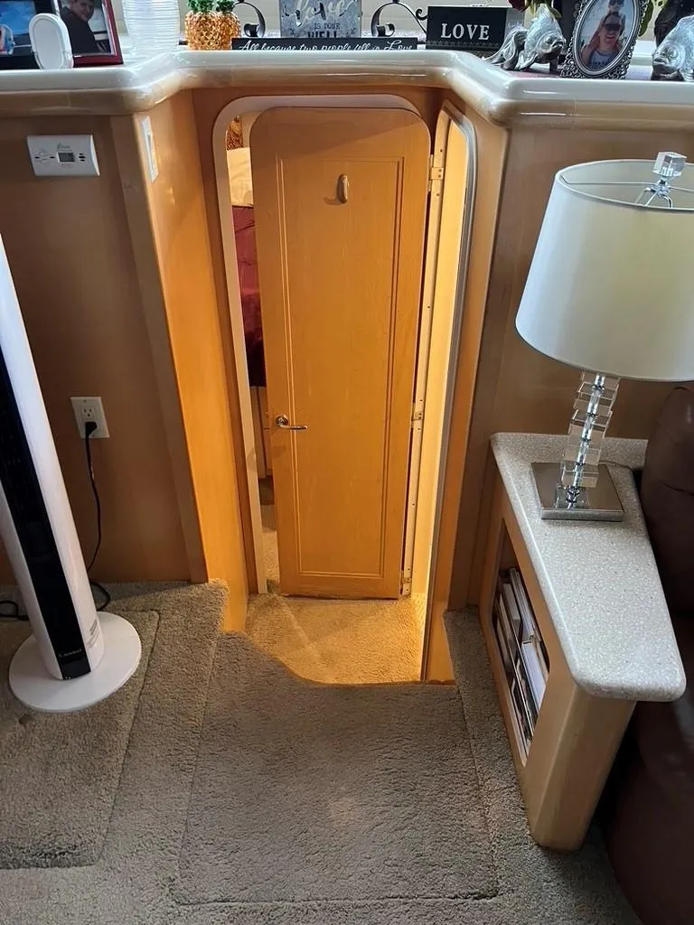 Slide: The Image of Interior of 1998 Carver 455 Aft Cabin Motoryacht with small door and cozy decor. - 18