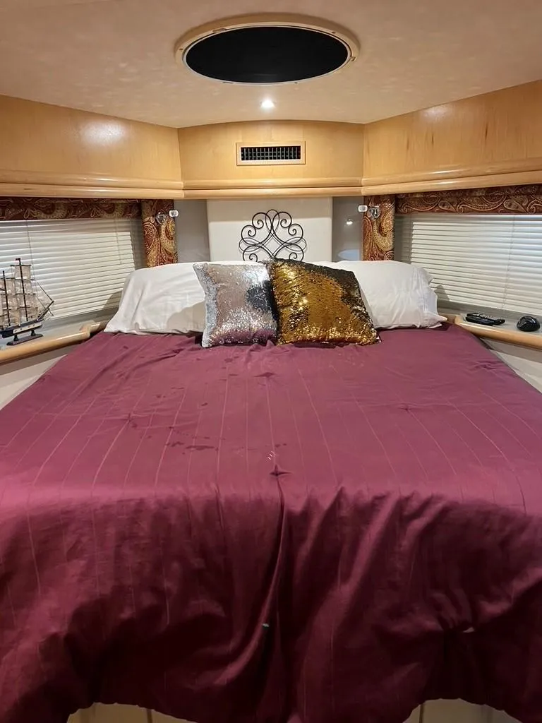 Slide: The Image of Luxurious bedroom in 1998 Carver 455 Aft Cabin Motoryacht with elegant decor and plush bedding. - 19