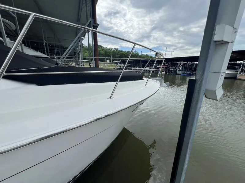 Slide: The Image of 1998 Carver 455 Aft Cabin Motoryacht docked at marina under cloudy sky. - 2