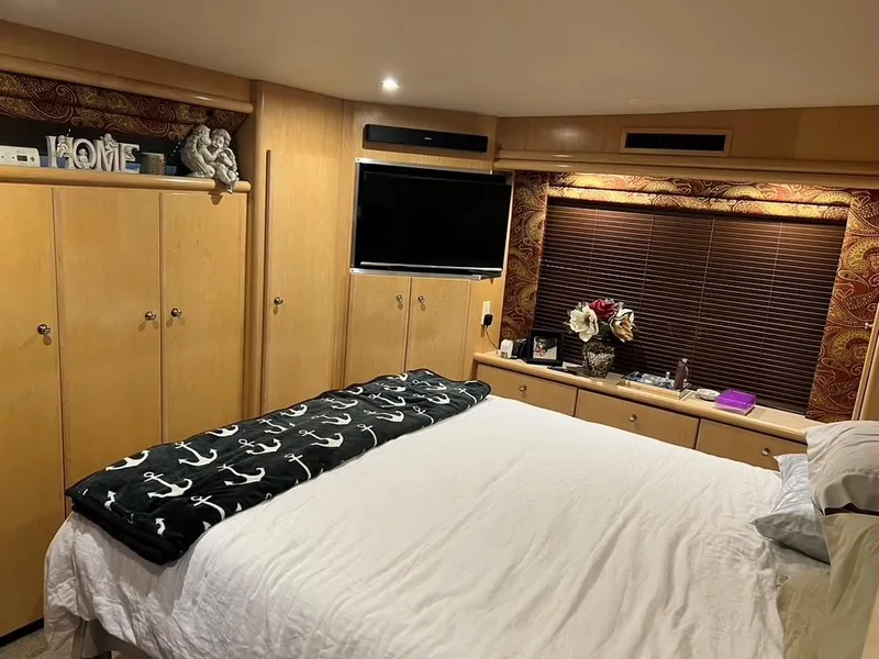 Slide: The Image of Cozy bedroom in 1998 Carver 455 Aft Cabin Motoryacht with wood cabinets and decor. - 23