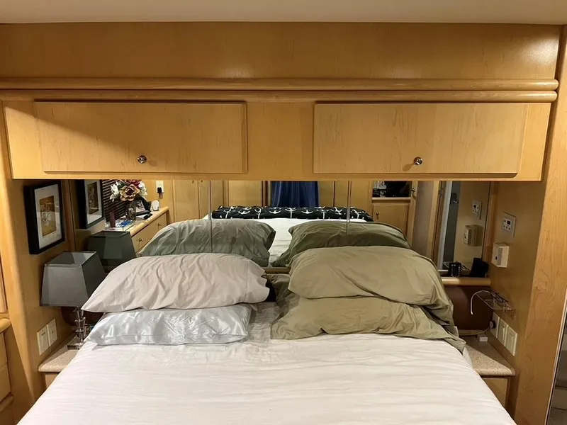 Slide: The Image of Interior of 1998 Carver 455 Aft Cabin Motoryacht bedroom with wooden cabinets and pillows. - 25