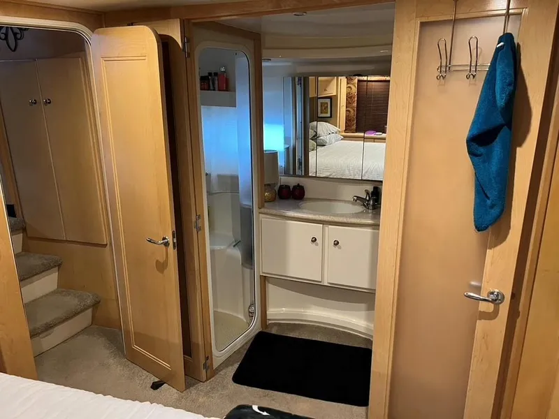 Slide: The Image of Interior of 1998 Carver 455 Aft Cabin Motoryacht with bathroom and wooden cabinetry. - 26