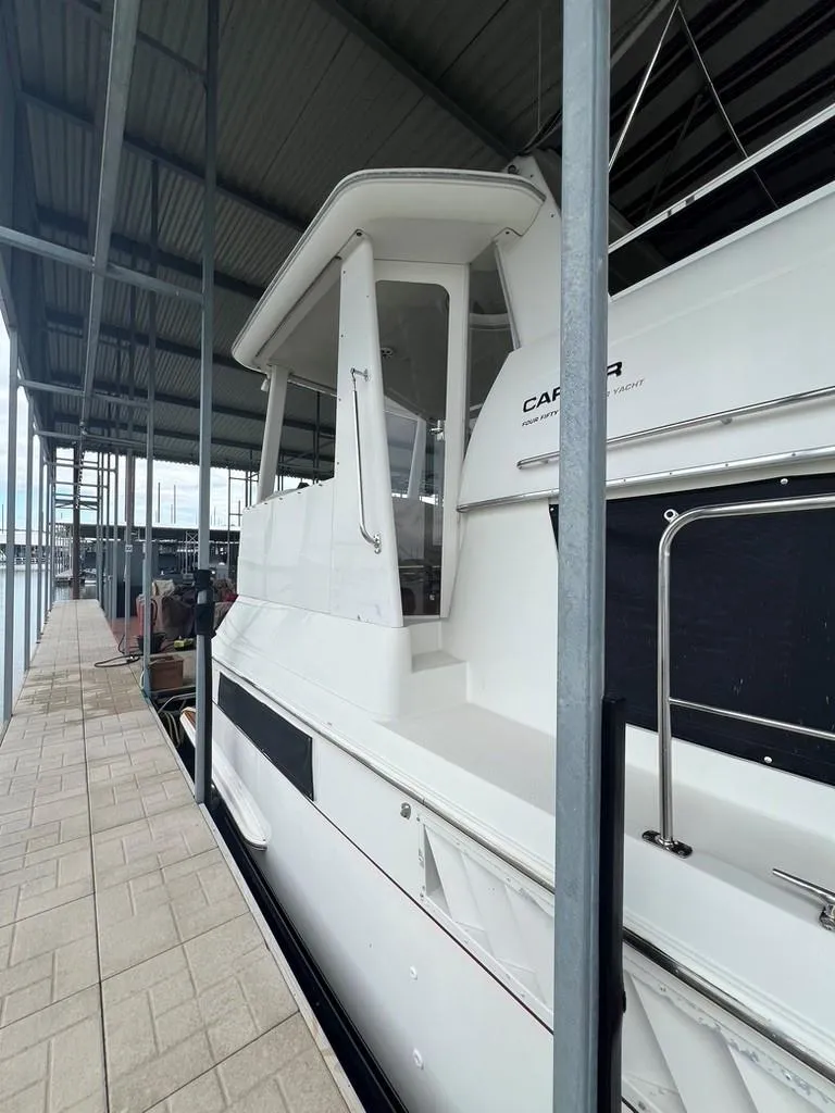Slide: The Image of 1998 Carver 455 Aft Cabin Motoryacht docked under covered marina. - 3