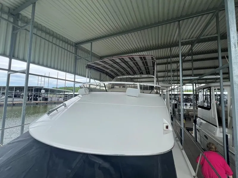 Slide: The Image of 1998 Carver 455 Aft Cabin Motoryacht docked under covered marina. - 35