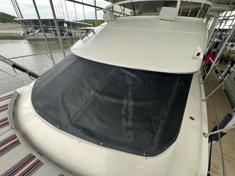 Slide: The Image of 1998 Carver 455 Aft Cabin Motoryacht docked at marina, covered windshield. - 36