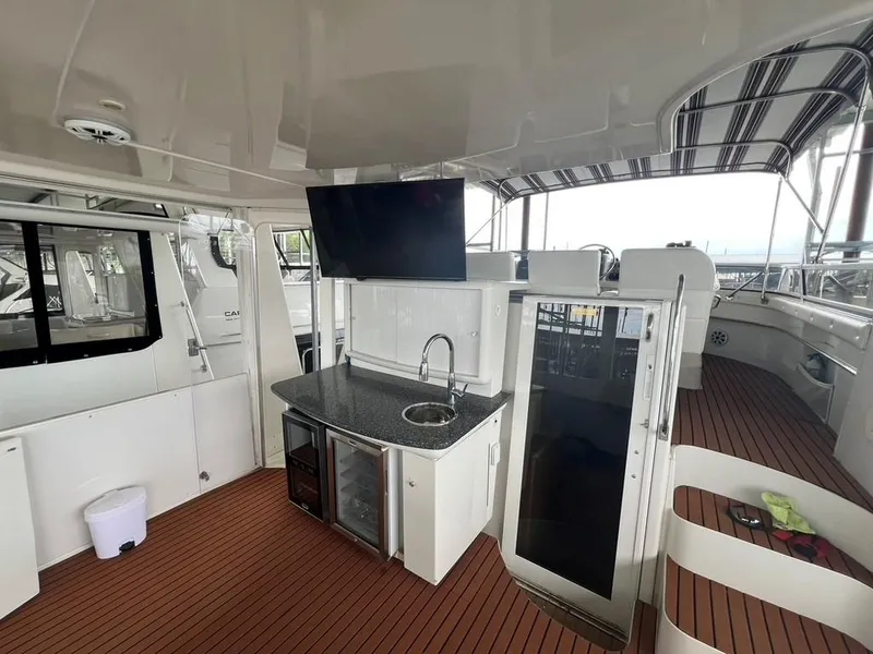 Slide: The Image of 1998 Carver 455 Aft Cabin Motoryacht interior with kitchenette and TV on deck. - 38