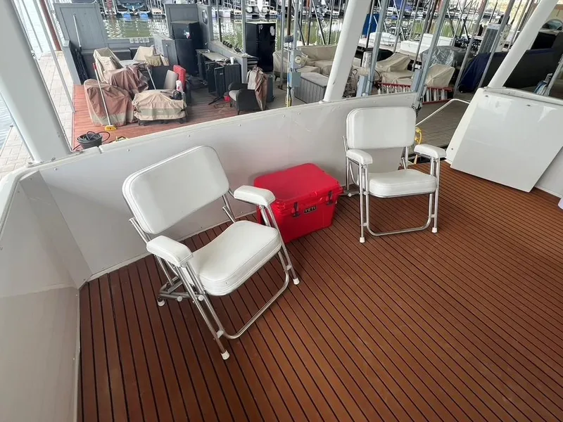 Slide: The Image of 1998 Carver 455 Aft Cabin Motoryacht deck with chairs and red cooler. - 40