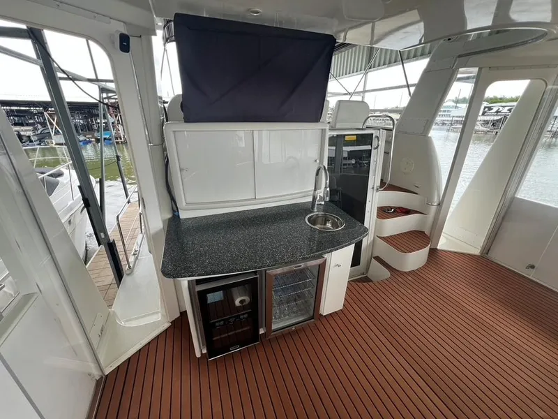 Slide: The Image of 1998 Carver 455 Aft Cabin Motoryacht interior with kitchenette and wood flooring. - 42