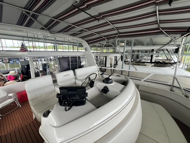 Slide: The Image of 1998 Carver 455 Aft Cabin Motoryacht interior with helm, seating, and covered deck. - 49
