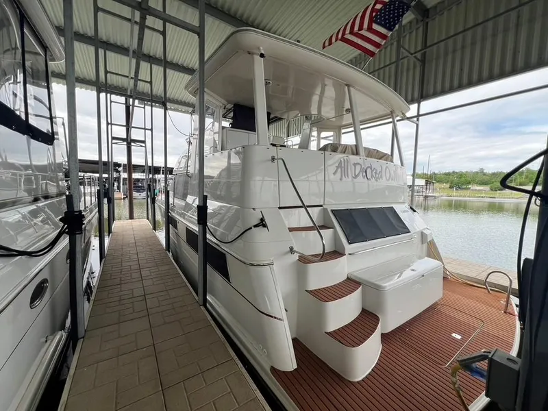 Slide: The Image of 1998 Carver 455 Aft Cabin Motoryacht docked under a covered marina. - 5