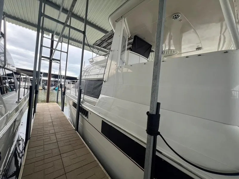 Slide: The Image of 1998 Carver 455 Aft Cabin Motoryacht docked under covered marina. - 6