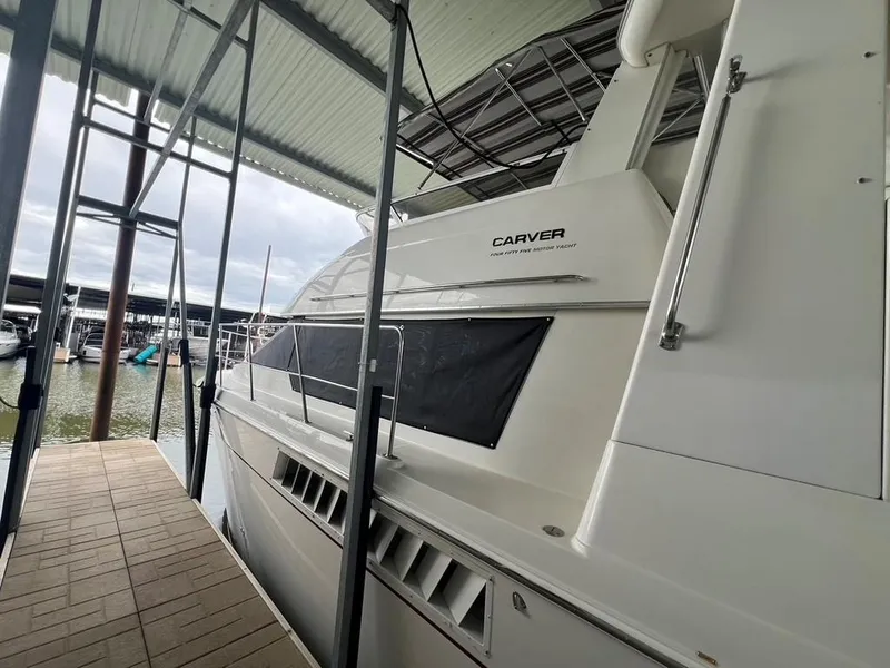 Slide: The Image of 1998 Carver 455 Aft Cabin Motoryacht docked under covered marina. - 7