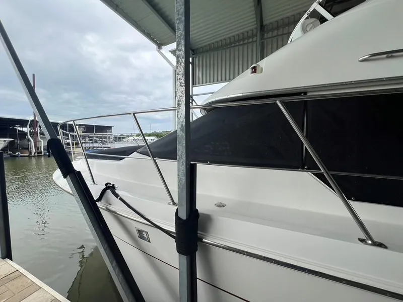 Slide: The Image of 1998 Carver 455 Aft Cabin Motoryacht docked under a covered marina. - 8