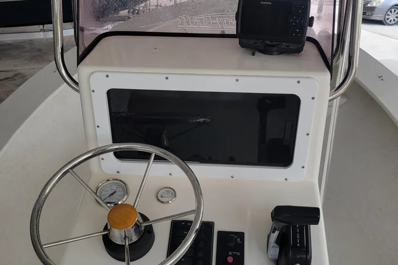 Slide: The Image of 2021 May-Craft 1800 Center Console boat dashboard with steering wheel and controls. - 5