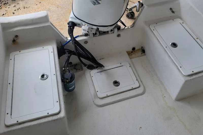 Slide: The Image of 2021 May-Craft 1800 Center Console boat interior with storage compartments and motor. - 7