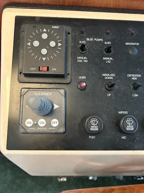 Slide: The Image of Control panel of a 2001 Nordic Tug 32 boat with various switches and buttons. - 17