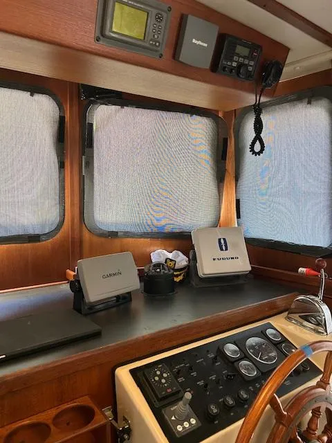 Slide: The Image of Control panel of a 2001 Nordic Tug 32 with navigation equipment and steering wheel. - 18