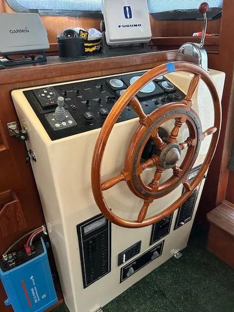 Slide: The Image of Steering wheel and control panel of a 2001 Nordic Tug 32 boat. - 19