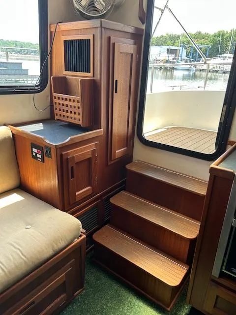 Slide: The Image of Interior of 2001 Nordic Tug 32, featuring wooden cabinetry and steps leading to deck. - 22