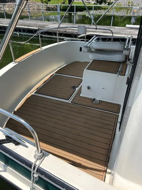 Slide: The Image of 2001 Nordic Tug 32 boat deck with wood finish and railing. - 23