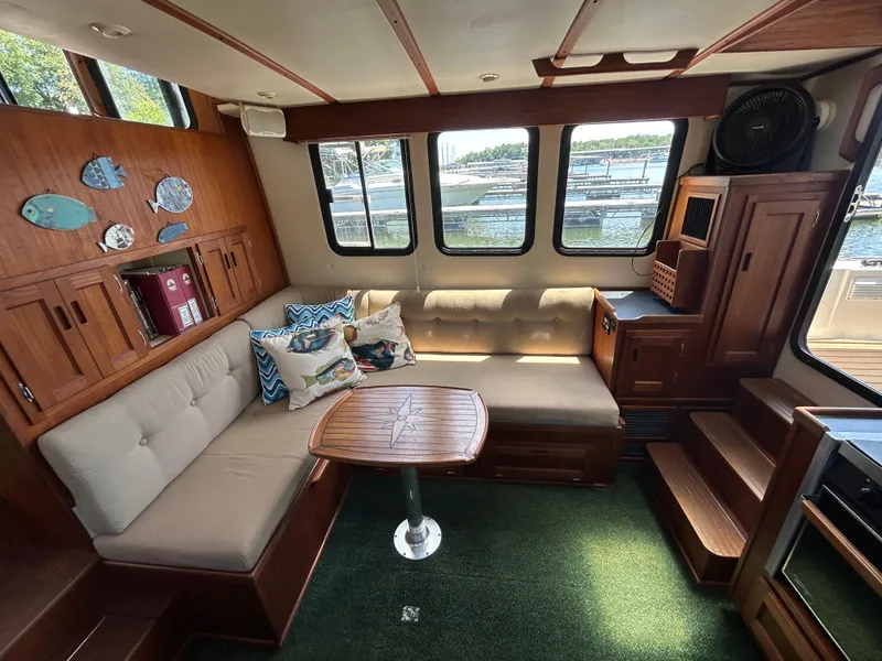 Slide: The Image of Cozy interior of 2001 Nordic Tug 32 with plush seating and nautical decor. - 28