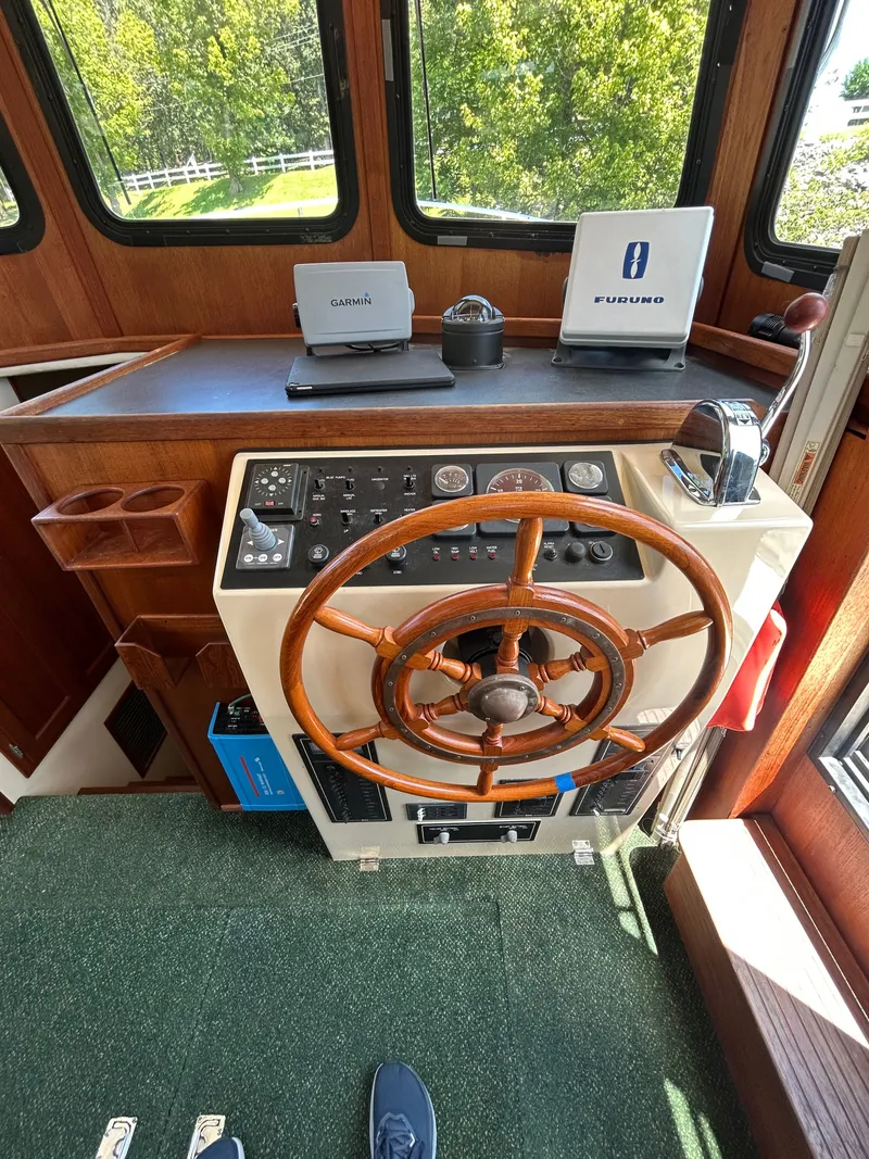 Slide: The Image of 2001 Nordic Tug 32 helm with wooden wheel, Garmin and Furuno navigation systems. - 31