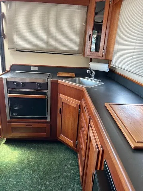 Slide: The Image of Interior of 2001 Nordic Tug 32 kitchen with wood cabinetry and appliances. - 6