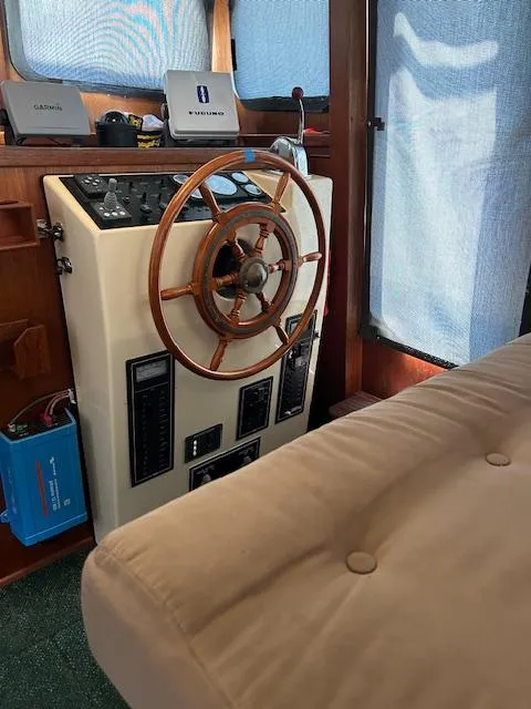 Slide: The Image of Interior helm of a 2001 Nordic Tug 32 with wooden steering wheel and navigation equipment. - 8