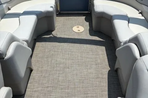 Slide: The Image of 2019 Bennington SSRX Pontoon 22 interior with gray seating and carpet flooring. - 15