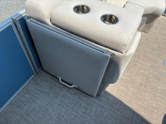 Slide: The Image of 2019 Bennington SSRX Pontoon 22 interior with cup holders and storage compartment. - 19