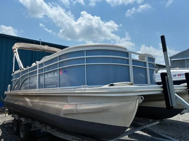Slide: The Image of 2019 Bennington SSRX Pontoon 22 on trailer under blue sky. - 2