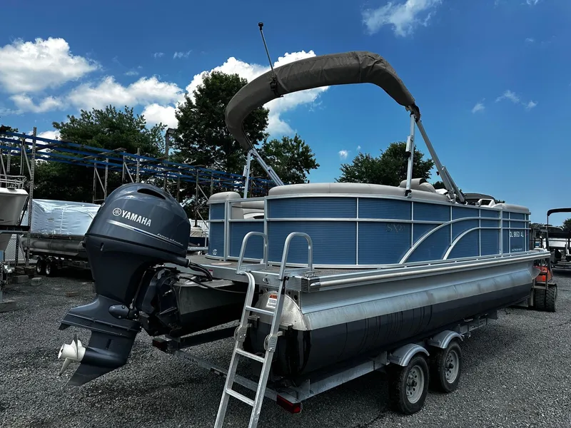 Slide: The Image of 2019 Bennington SSRX Pontoon 22 with Yamaha engine on trailer, parked outdoors. - 3