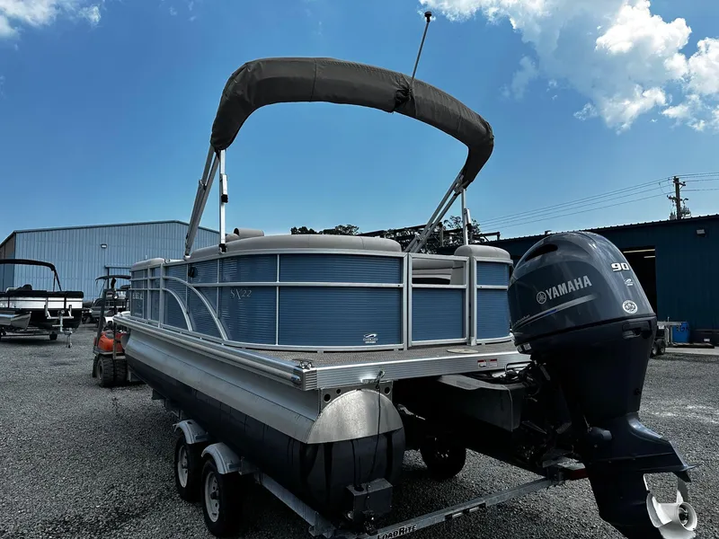 Slide: The Image of 2019 Bennington SSRX Pontoon 22 with Yamaha motor on trailer, parked outdoors. - 4