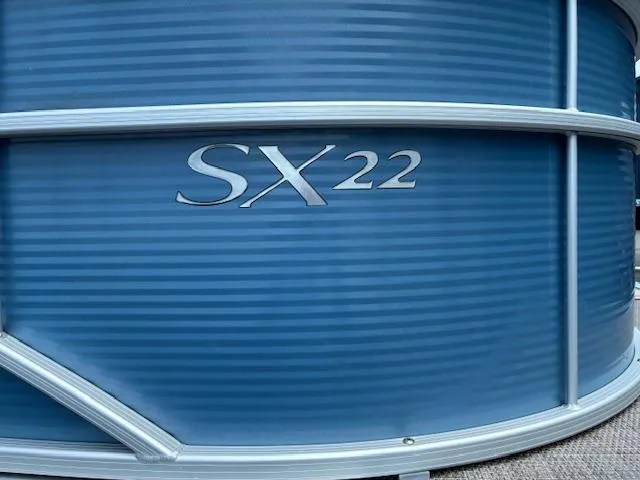 Slide: The Image of 2019 Bennington SSRX Pontoon 22, blue exterior with "SX22" emblem. - 6