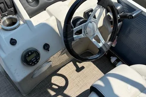 Slide: The Image of 2019 Bennington SSRX Pontoon 22 steering console with controls and seating. - 8