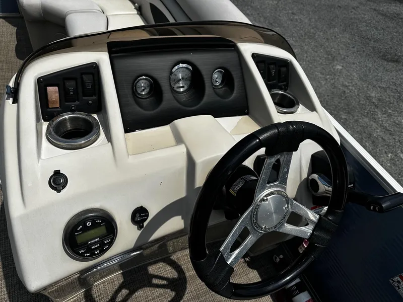 Slide: The Image of 2019 Bennington SSRX Pontoon 22 dashboard with steering wheel and control panel. - 9