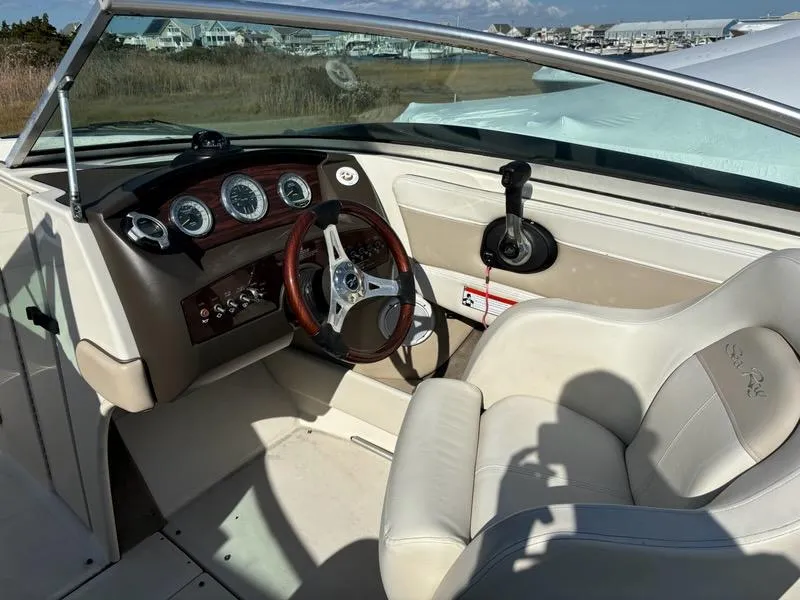 Slide: The Image of Interior of a 2010 Sea Ray 210 Select boat, featuring steering wheel and dashboard controls. - 3